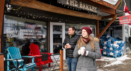 two people walking infront of Canoe Fine Foods in Washago