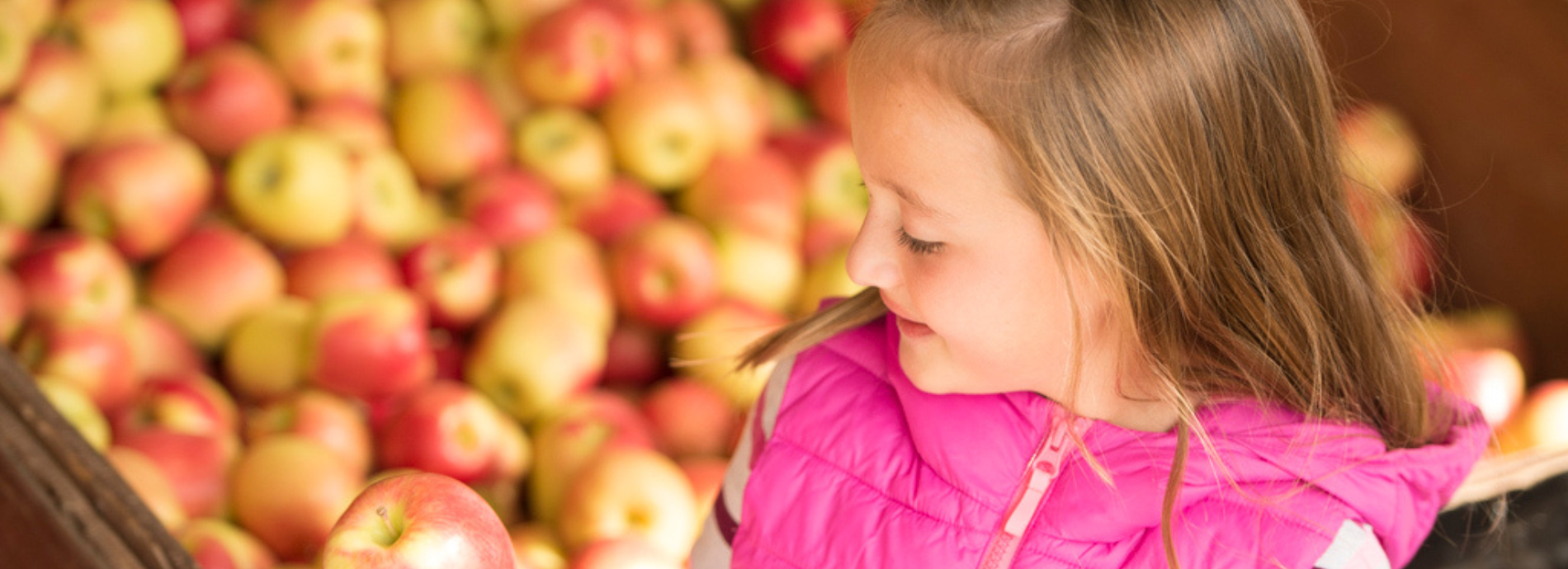 young child at an outdoor fruit market