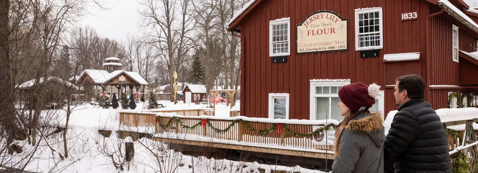 two people standing on the bridge by the Coldwater Mill